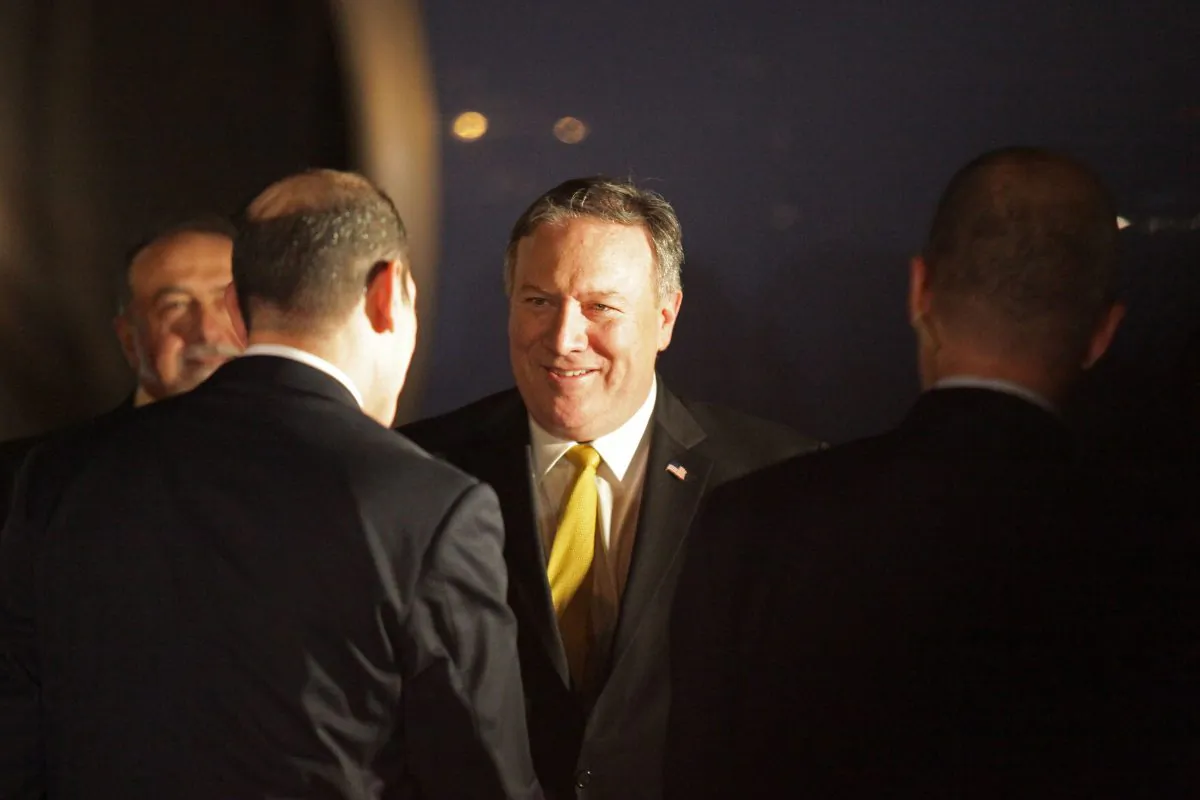 Secretary of State Mike Pompeo shakes hands after disembarking from his plane as he arrives at the Queen Alia International Airport in Amman on 29 April, 2018. (Photo by AHMAD ABDO / AFP)        (Photo credit should read AHMAD ABDO/AFP/Getty Images)