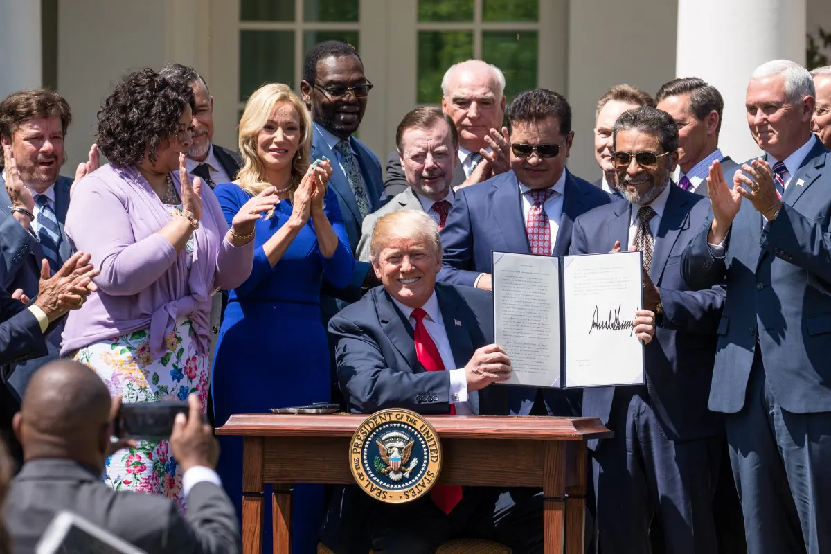 President Donald Trump signs an Executive Order entitled “Establishment of a White House Faith and Opportunity Initiative” at the National Day of Prayer in the Rose Garden of the White House in Washington on May 3, 2018. (Samira Bouaou/The Epoch Times)