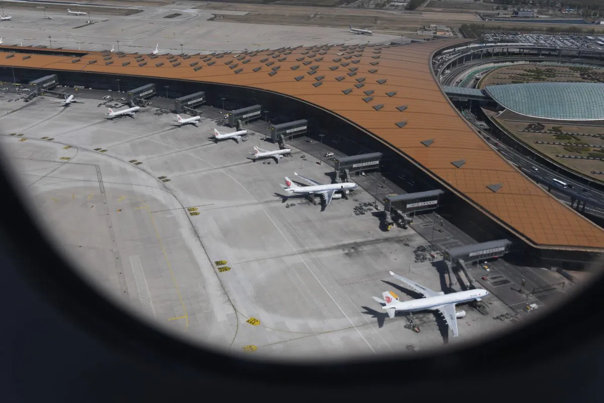 This aerial view taken through the window of a plane, shows various Airbus A330 and Boeing 737 planes of Air China parked at Beijing's capital airport on April 11, 2018. (Greg Baker/AFP/Getty Images)