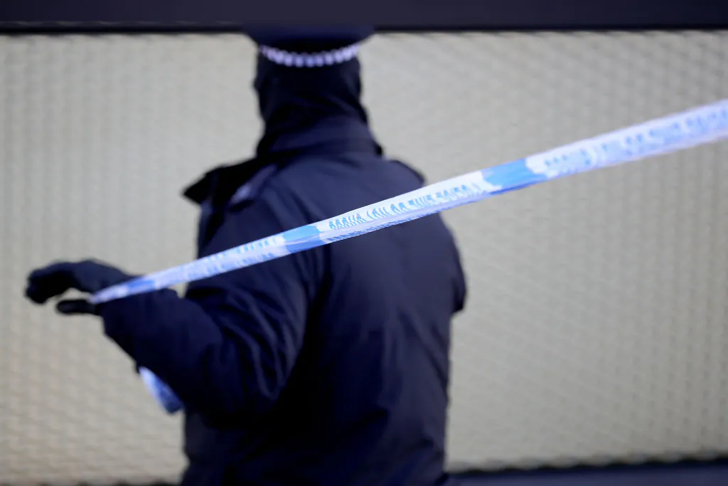 A British police officer sets up a cordon near the scene where a man, 20, was fatally stabbed in London on April 5, 2018. (Christopher Furlong/Getty Images)