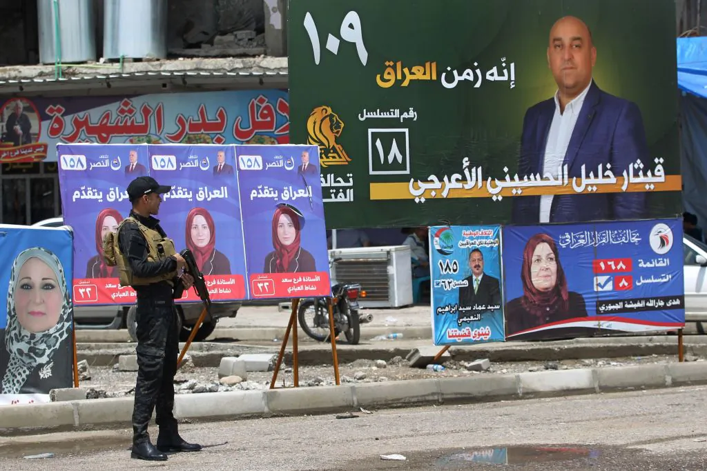 An Iraqi policeman guards a checkpoint by electoral posters in the old town of Mosul on May 11, 2018,       (Ahamd Al-Rubaye/AFP/Getty Images)