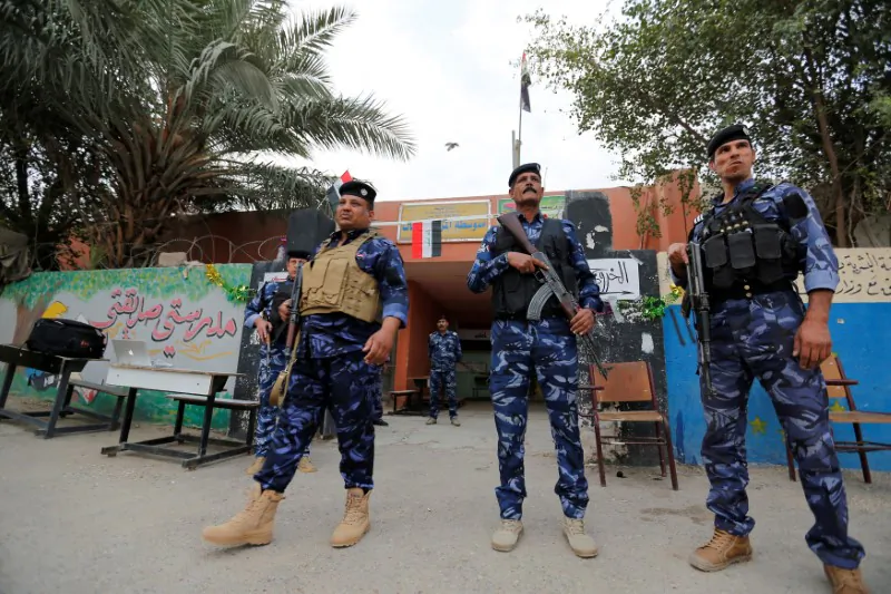 Iraqi security forces stand guard outside a polling station during the parliamentary election in the Sadr city district of Baghdad, Iraq May 12, 2018. (Reuters/Wissm al-Okili)