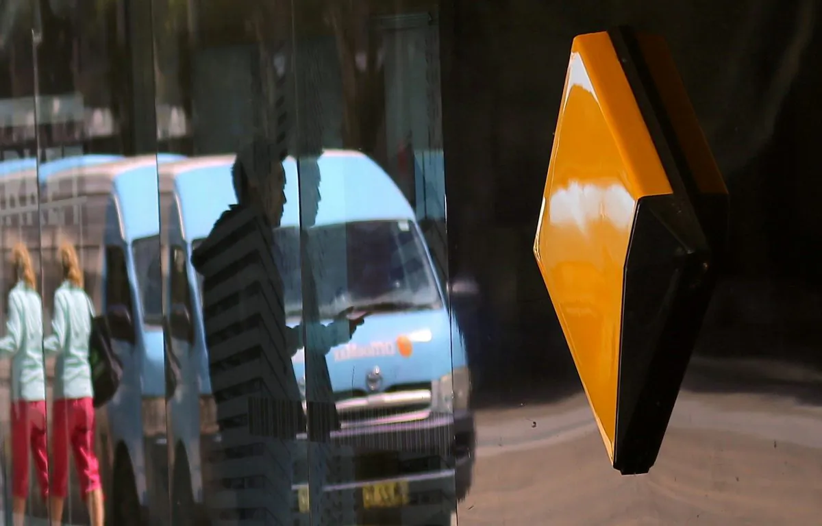 Pedestrians are reflected in the window of a branch of the Commonwealth Bank of Australia (CBA), Australia's biggest bank by market value, in Sydney, Australia, on Nov. 8, 2017. (Reuters/Steven Saphore/File Photo)