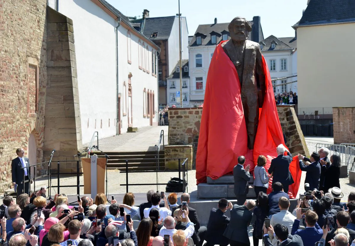 Visitors look on as a statue of German communist thinker Karl Marx is unveiled on May 5, 2018 in his native city of Trier, in southwestern Germany. (HARALD TITTEL/AFP/Getty Images)