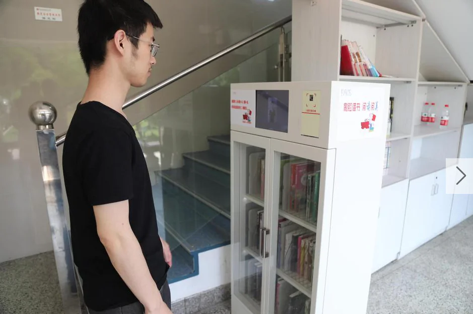 A student at Hangzhou Number 11 High School gets his face scanned before retrieving books from the classroom library, in Hangzhou City in eastern China. (Screenshot via Sina)