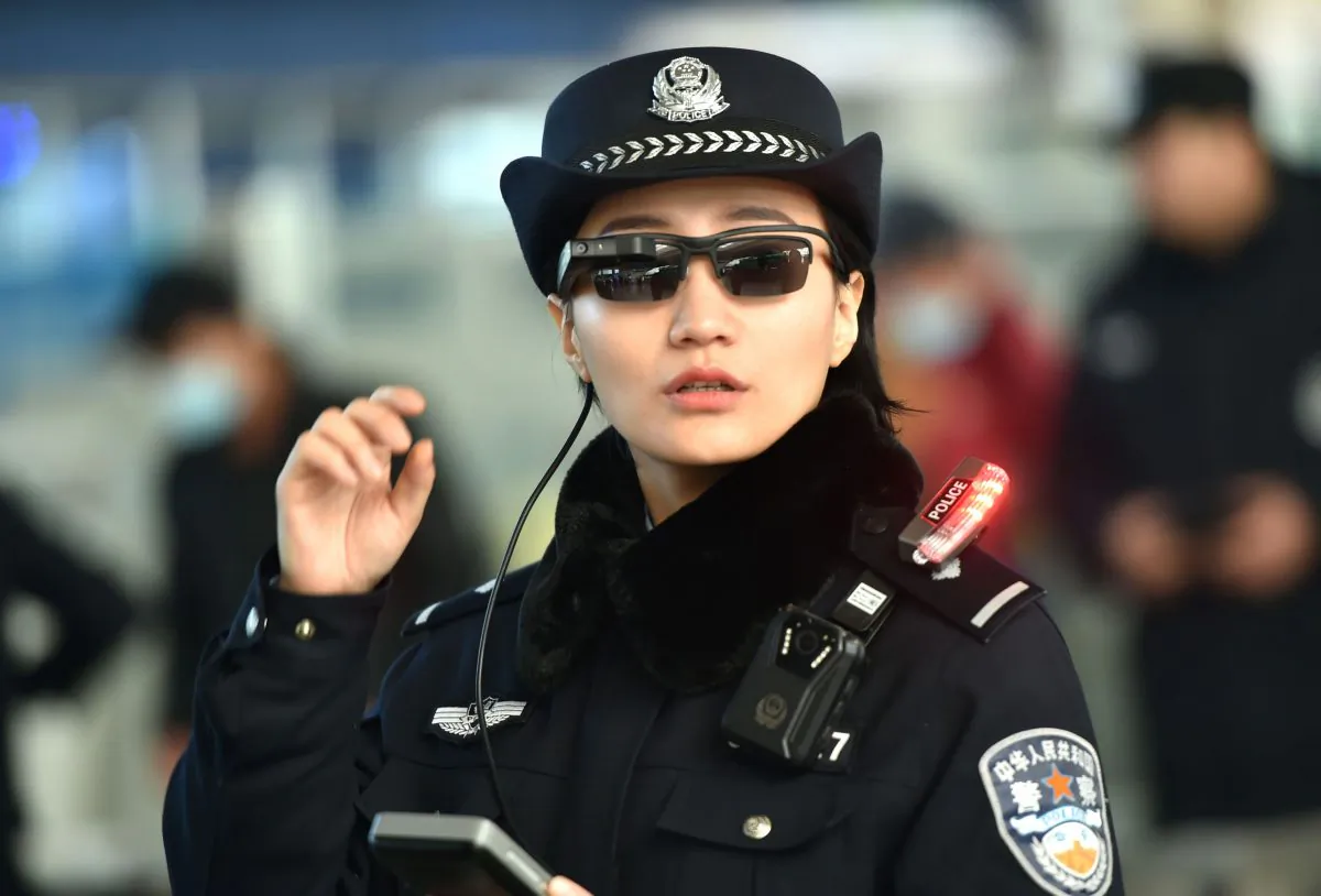 A police officer wearing a pair of smart glasses fitted with a facial recognition system at the Zhengzhou East Railway Station in Zhengzhou City, in China's central Henan Province on February 5, 2018. (AFP/Getty Images)
