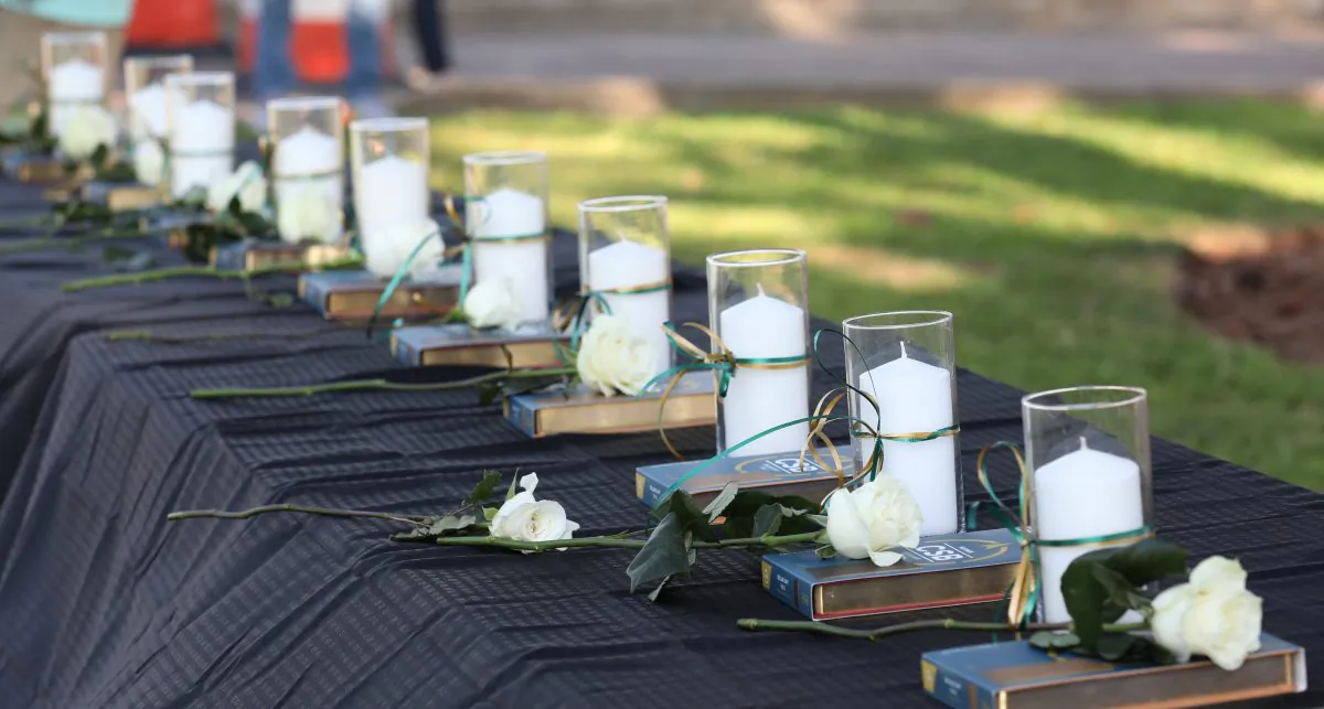 Candles line a table during a vigil held at the Texas First Bank after a shooting left several people dead at Santa Fe High School in Santa Fe, Texas on May 18, 2018. (REUTERS/Trish Badger)