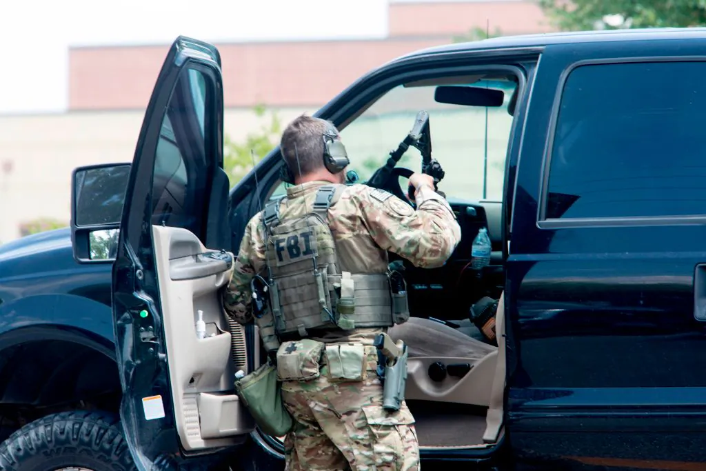 An FBI agent is seen in the parking lot of Santa Fe High School where at least eight people were killed on May 18, 2018 in Santa Fe, Texas. (Daniel Kramer/AFP/Getty Images)