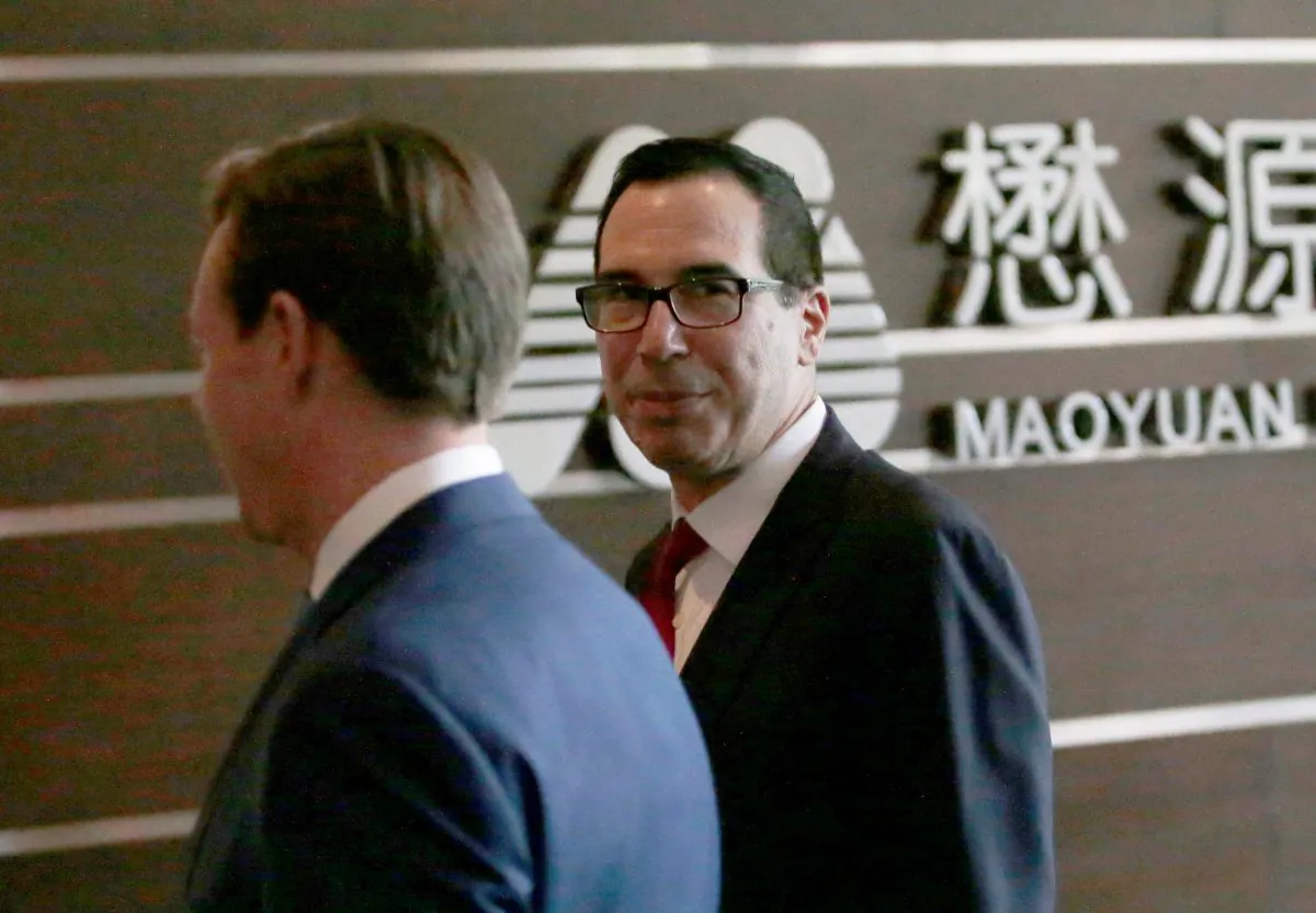 U.S. Treasury Secretary Steven Mnuchin (R) is seen as he and a U.S. delegation for trade talks with China arrive at a hotel in Beijing, China on May 3, 2018. (REUTERS/Jason Lee)