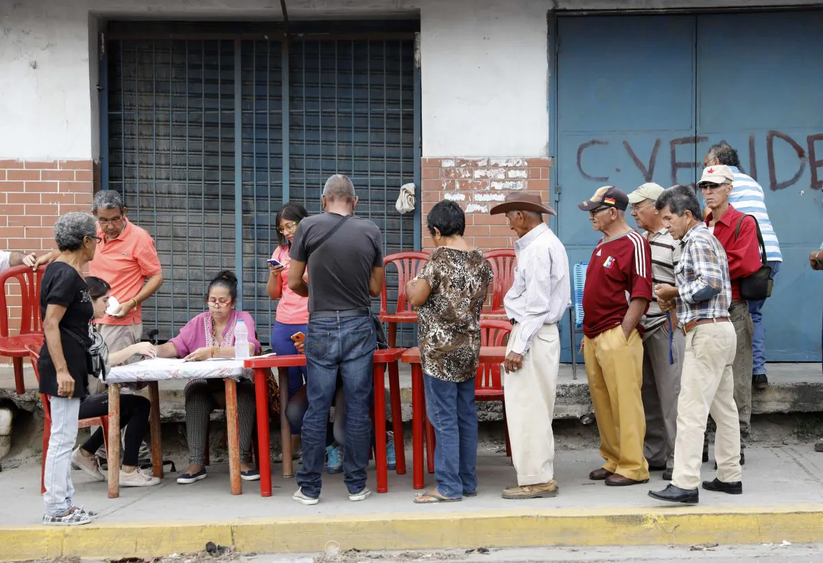 Venezuelan citizens check in at a "Red Point," an area set up by President Nicolas Maduro's party, to verify that they cast their votes during the presidential election in Barquisimeto, Venezuela, May 20, 2018. (Reuters/Carlos Jasso)