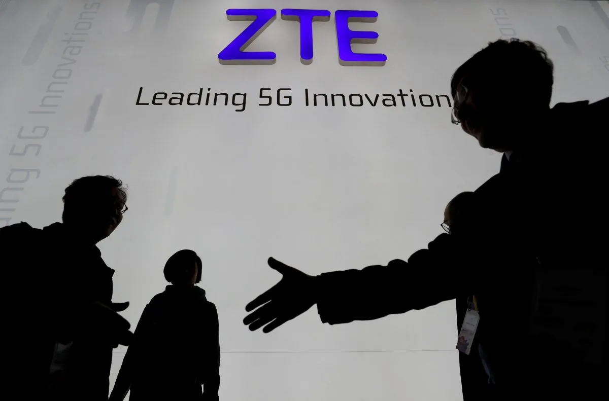 Visitors pass in front of the Chinese telecoms equipment firm ZTE, at the Mobile World Congress in Barcelona, Spain, on February 26, 2018. (Yves Herman/File Picture/Reuters)