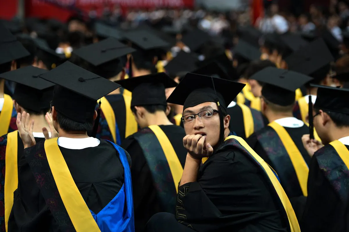 Students at the Huazhong University of Science and Technology graduation ceremony in a sports stadium in Wuhan City, in China's central Hubei Province, on June 20, 2017. (STR/AFP/Getty Images)