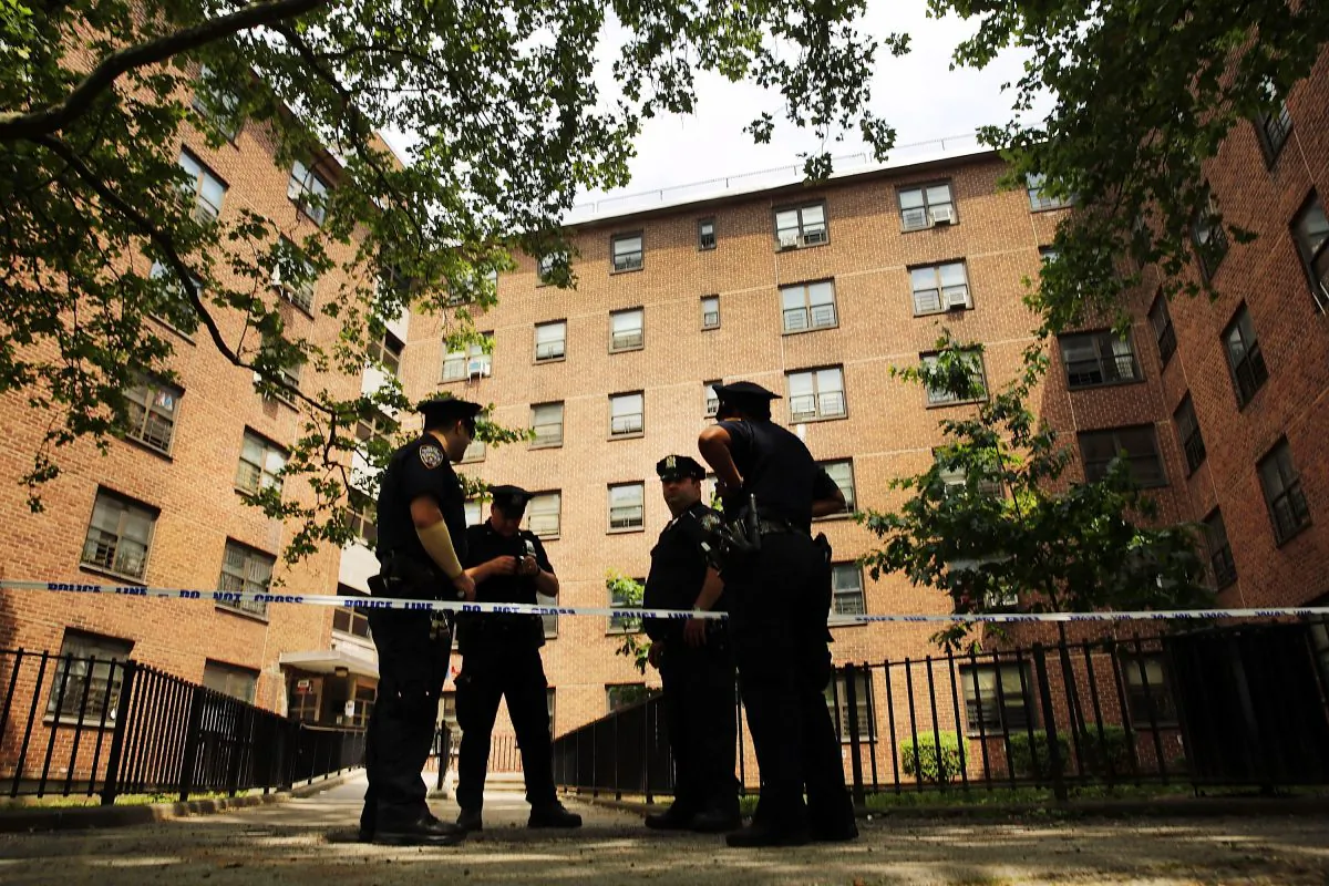Police stand near the entrance to the building where two children were attacked with a knife in an East New York neighborhood apartment building elevator on June 4, 2014 in the Brooklyn borough of New York City.  (Spencer Platt/Getty Images)