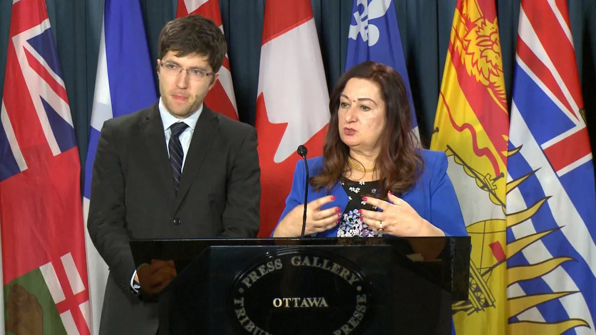 Sen. Salma Ataullahjan speaks about her bill to combat organ trafficking while MP Garnett Genuis looks on at a Parliament Hill press conference in Ottawa on Dec. 12, 2017. (Limin Zhou/The Epoch Times)