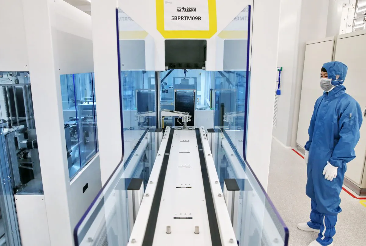 A Chinese employee looking at a solar cell production line at a factory in Nantong in Jiangsu Province in eastern China on March 28, 2018. (AFP/Getty Images)