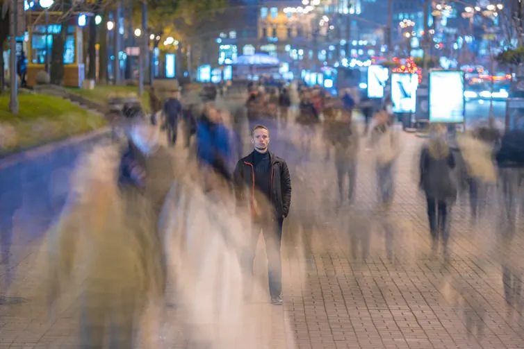 Alone in the crowd, but not lonely. (Realstock/shutterstock)