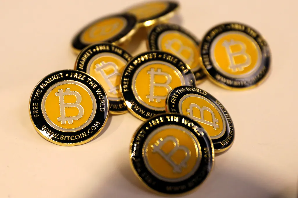 Bitcoin buttons are seen displayed on the floor of the Consensus 2018 blockchain technology conference in New York on May 16, 2018. (Mike Segar/Reuters)
