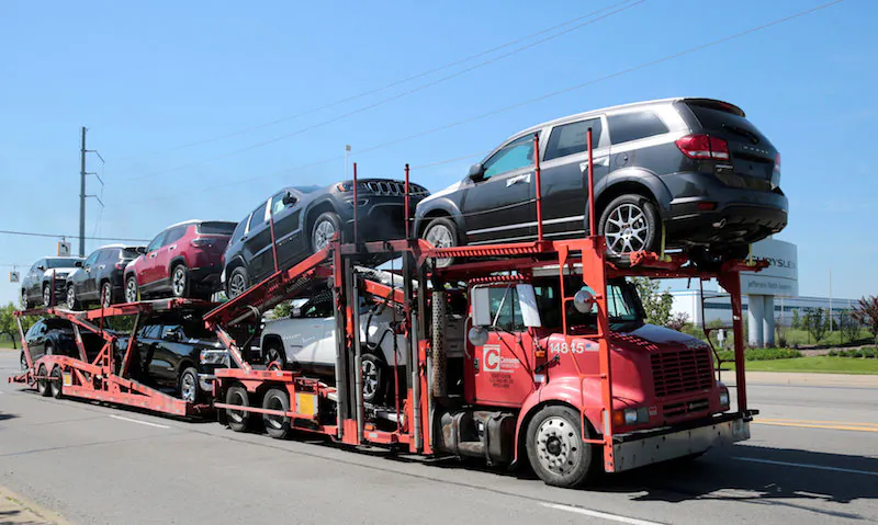 A car hauler transports Chrysler vehicles from the FCA Jefferson North Assembly Plant in Detroit on May 25, 2018.  (Reuters/Rebecca Cook)
