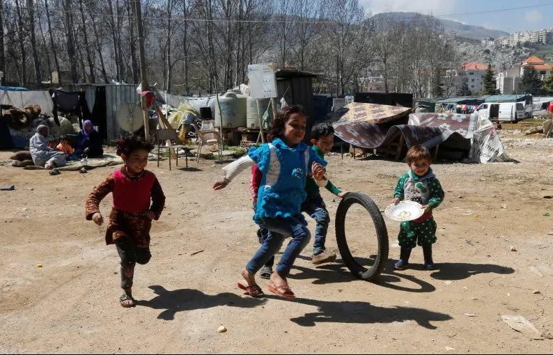 Syrian refugee children run in a tented settlement, in the town of Qab Elias, in Lebanon's Bekaa Valley, March 13, 2018. (Reuters/Mohamed Azakir)