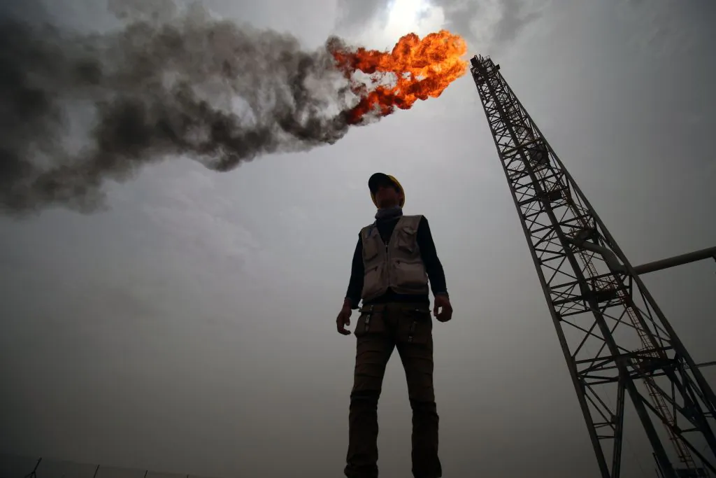 An employee stands at the Hammar Mushrif Degassing Station Facilities site inside the Zubair oil and gas field, north of the southern Iraqi province of Basra on May 9, 2018. (Haidar Mohammed Ali/AFP/Getty Images)