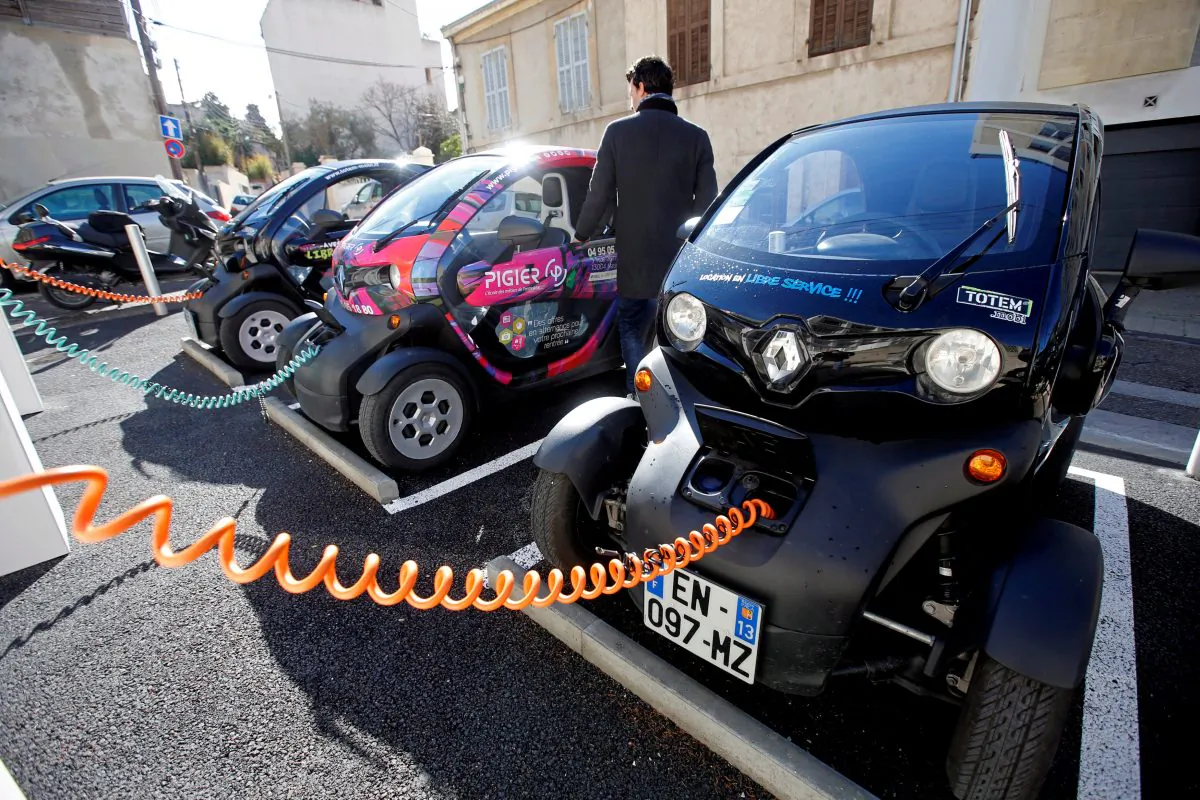 A man prepares to drive a Totem-Mobi electric car-sharing vehicle parked at a charging station in Marseille, France March 6, 2018. (Reuters/Jean-Paul Pelissie//File Photo)