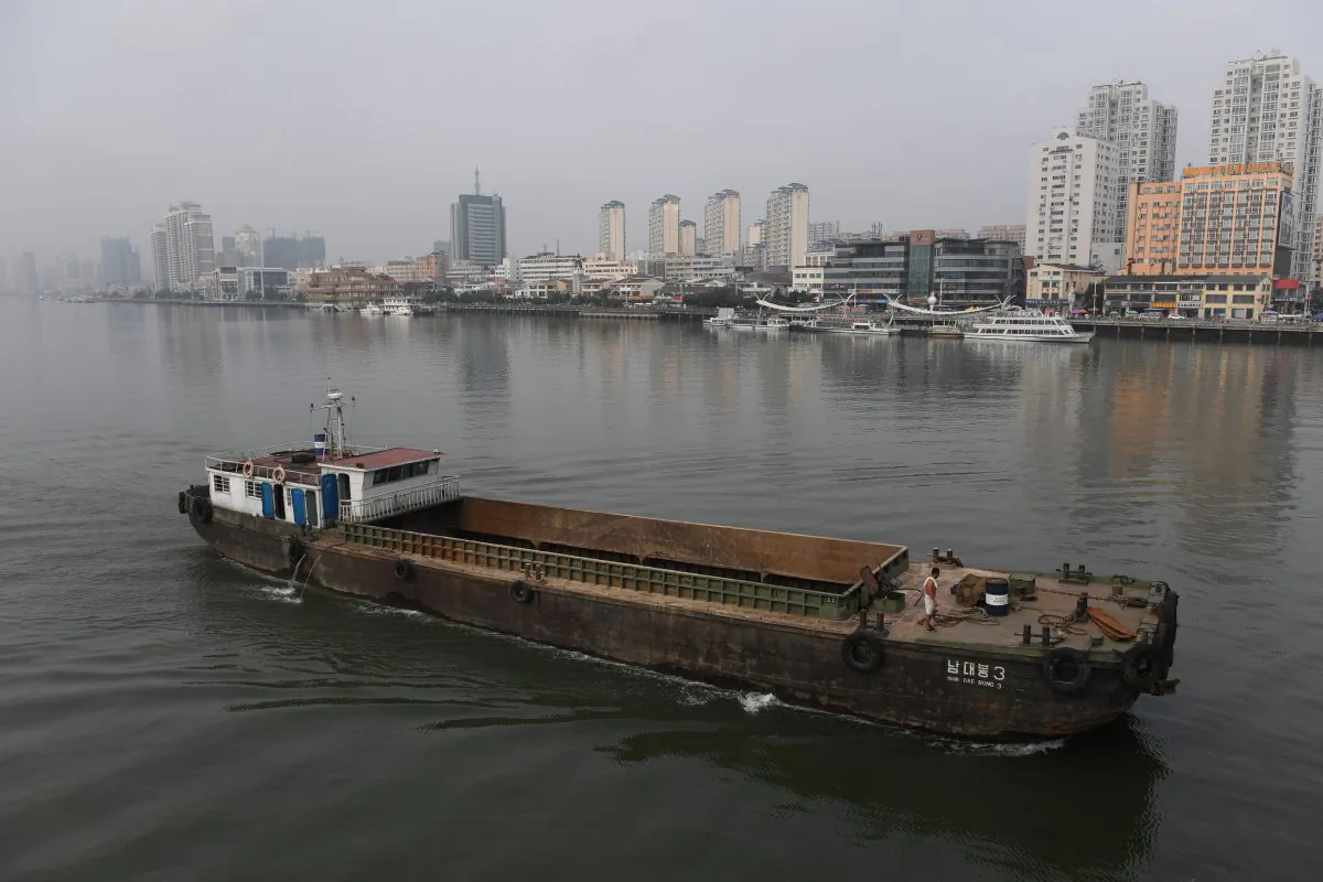 A North Korean ship passes in front of the Chinese border city of Dandong (at rear), in China's northeast Liaoning Province, on September 4, 2017. (Greg Baker/AFP/Getty Images)