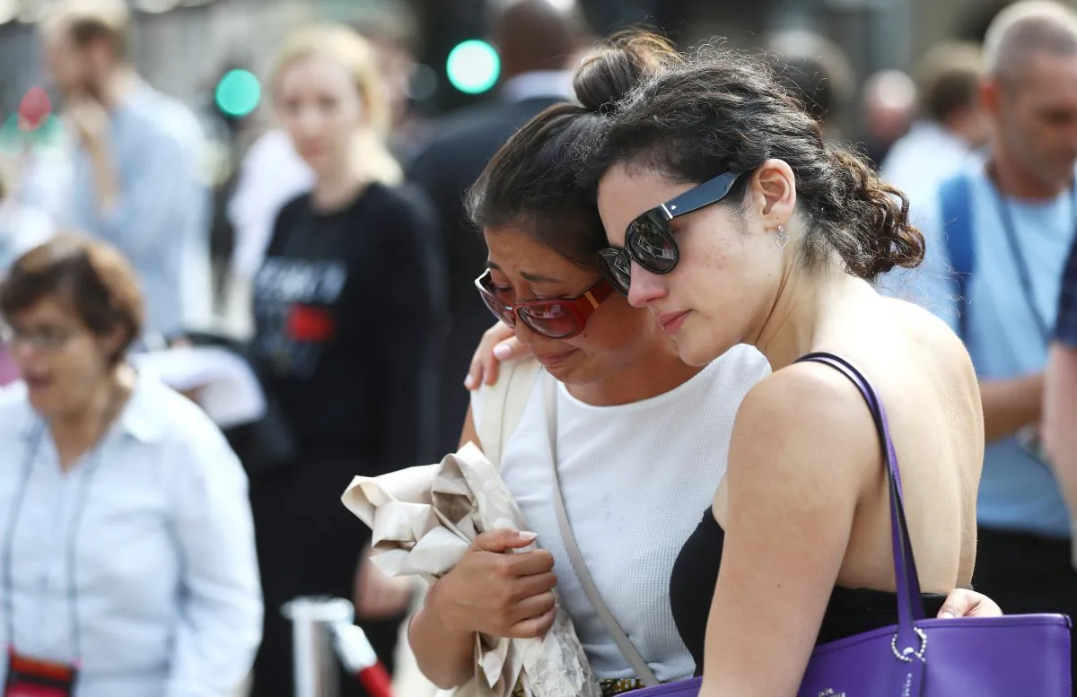 Two women comfort each other during commemorations of the first anniversary of the attack on London Bridge, London that was carried out on June 3, 2017. (Reuters/Simon Dawson)