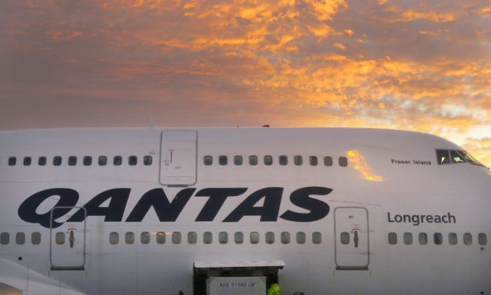 A worker unloads a Qantas Airways Boeing 747 at Sydney's International airport in Australia on June 24, 2017. (David Gray/Reuters)