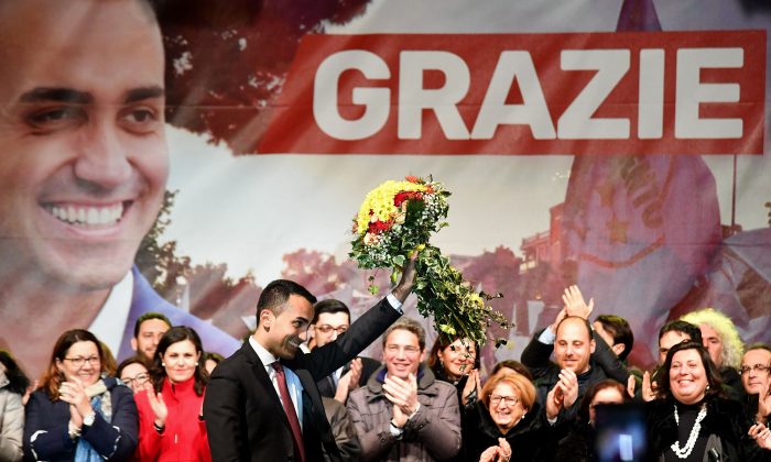 Italy's populist Five Star Movement (M5S) party leader Luigi Di Maio (C) waves flowers as he celebrates with supporters in his home town of Pomigliano on March 6, 2018, after Italy's general elections. (ALBERTO PIZZOLI/AFP/Getty Images)