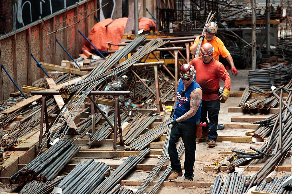 Construction laborers work on the site of a new residential building in the Hudson Yards development in New York City on Aug. 16, 2016. With the tightening labor market, there are not enough Americans available to take infrastructure jobs, say industry experts. (Drew Angerer/Getty Images)