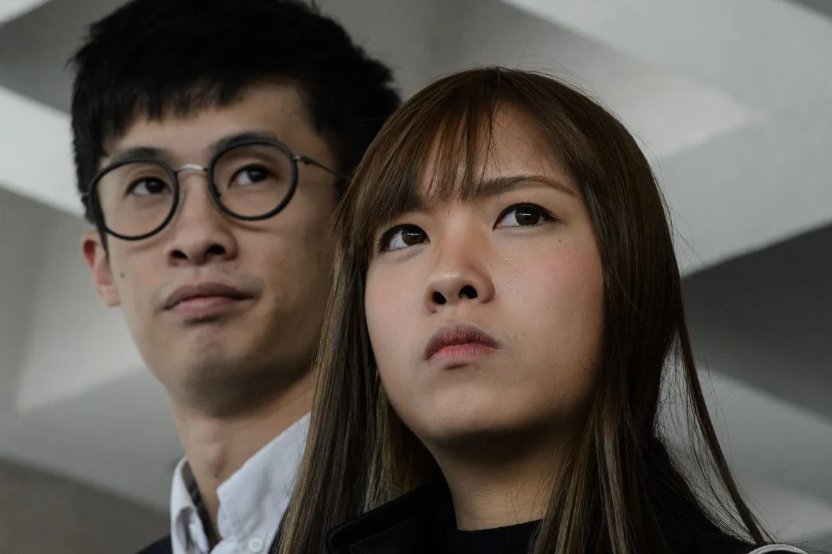 Former Hong Kong lawmakers Baggio Leung (L) and Yau Wai-ching speak to the press outside the High Court in Hong Kong on November 30, 2016. They were recently sentenced to a four-week jail term. (Anthony Wallace/AFP/Getty Images)