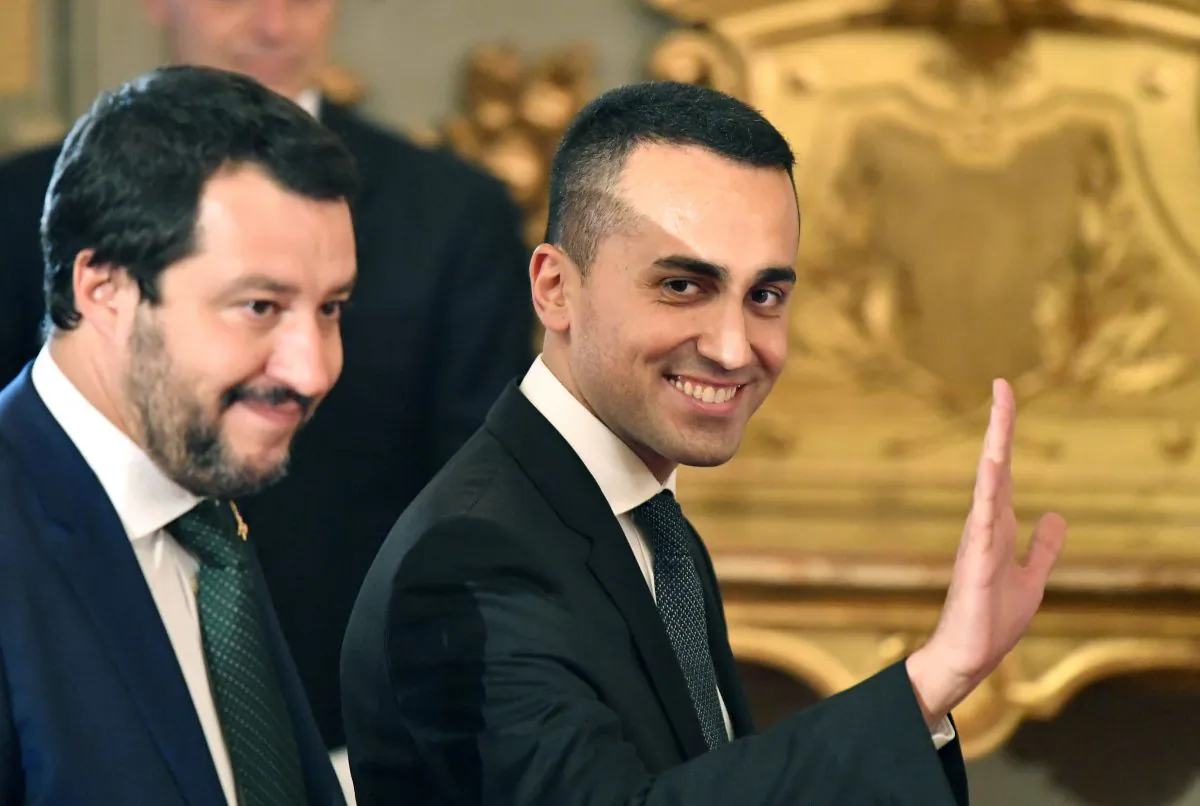 Italy’s Labor and Industry Minister and deputy Prime Minister Luigi Di Maio (R) waves as he arrives with Italy’s Interior Minister and deputy Prime Minister Matteo Salvini for the swearing in ceremony of the new government at Quirinale Palace in Rome on June 1, 2018 (ALBERTO PIZZOLI/AFP/Getty Images)