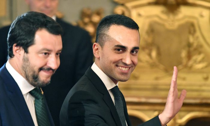 Italy’s Labor and Industry Minister and deputy Prime Minister Luigi Di Maio (R) waves as he arrives with Italy’s Interior Minister and deputy Prime Minister Matteo Salvini for the swearing in ceremony of the new government at Quirinale Palace in Rome on June 1, 2018 (ALBERTO PIZZOLI/AFP/Getty Images)