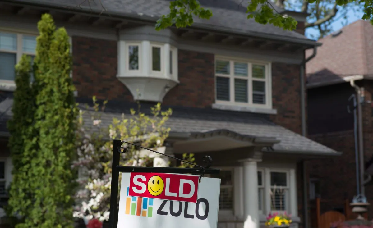 A sold sign is shown in front of a west-end Toronto home in this file photo. The housing bubbles in Vancouver and Toronto appear to be gradually deflating, but affordability is still extremely poor. (The Canadian Press/Graeme Roy)