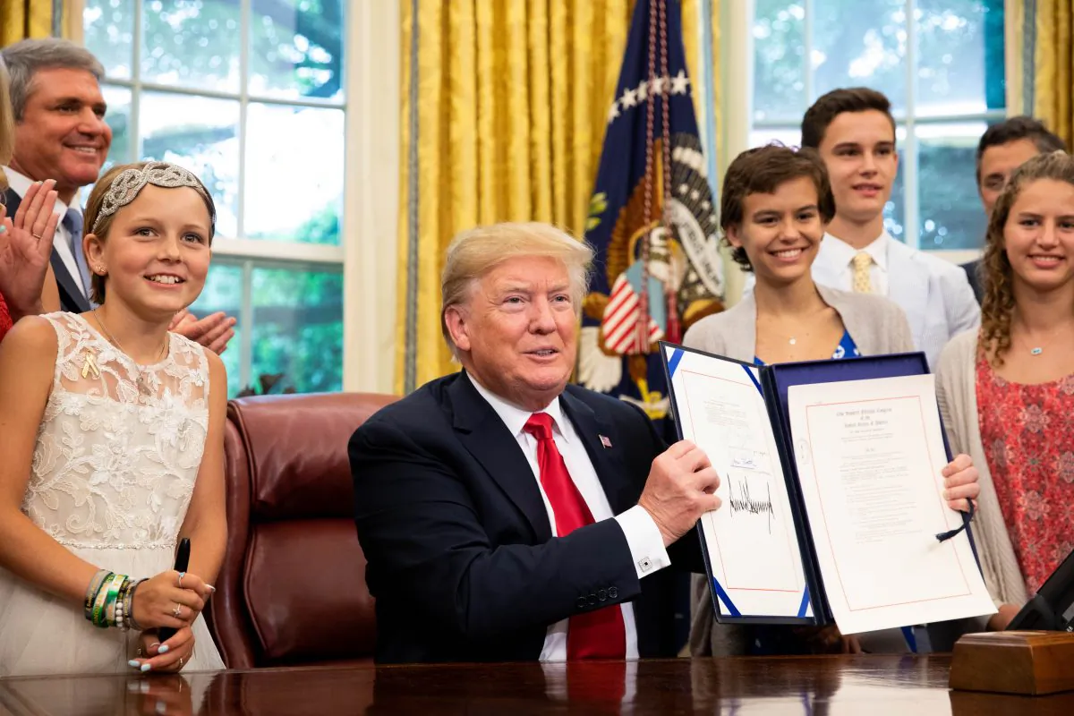 President Donald Trump participates in the signing ceremony for S. 292 – The Childhood Cancer Survivorship, Treatment, Access, and Research Act of 2018 in the Oval Office at the White House in Washington on June 5, 2018. (Samira Bouaou/The Epoch Times)