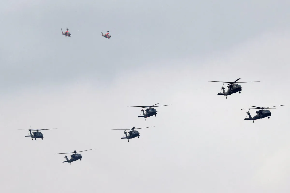 UH-60M Black Hawk helicopters and AH-1 Cobra helicopters take part in Taiwan's annual Han Kuang Exercises as they simulate China's army invading the island, at Ching Chuan Kang Air Base, in Taichung, Taiwan, on June 7, 2018. (Tyrone Siu/Reuters)