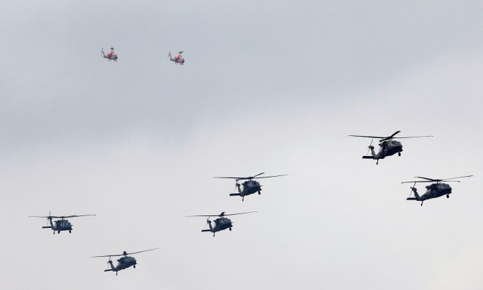 UH-60M Black Hawk helicopters and AH-1 Cobra helicopters take part in Taiwan's annual Han Kuang Exercises as they simulate China's army invading the island, at Ching Chuan Kang Air Base, in Taichung, Taiwan, on June 7, 2018. (Tyrone Siu/Reuters)
