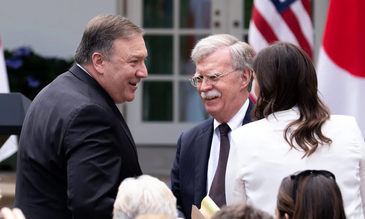 Secretary of State Mike Pompeo and National Security Advisor John Bolton chat in the White House Rose Garden prior to the joint press conference between Japan and the United States, in Washington on June 7, 2018. (Samira Bouaou/The Epoch Times)