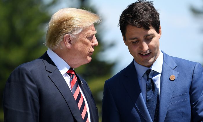 Prime Minister of Canada Justin Trudeau (R) speaks with President Donald Trump during the G7 official welcome at Le Manoir Richelieu on day one of the G7 meeting in Quebec City, Canada on June 8, 2018. (Leon Neal/Getty Images)