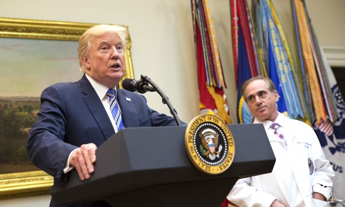 President Donald J. Trump speaks as U.S. Veterans Affairs Secretary Dr. David Shulkin (R) listens during a Department of Veterans Affairs announcement of a new program using video and software technology to provide medical care to veterans at the White House Aug. 3, 2017 in Washington, DC.  (Chris Kleponis-Pool/Getty Images)