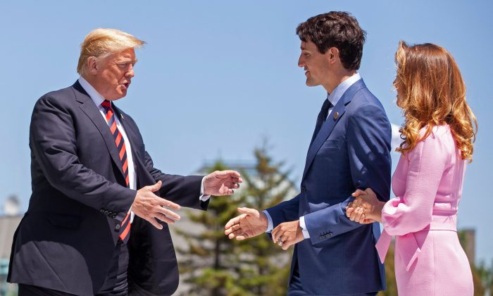 U.S. President Donald Trump is greeted by Canadian Prime Minister Justin Trudeau and his wife Sophie Gregoire Trudeau on the first day of the G7 Summit in La Malbaie, Quebec, Canada, June 8, 2018.  Canada should welcome the U.S. offers for trade liberalization rather than double down on protectionism. (Geoff Robins/ AFP/Getty Images)   
