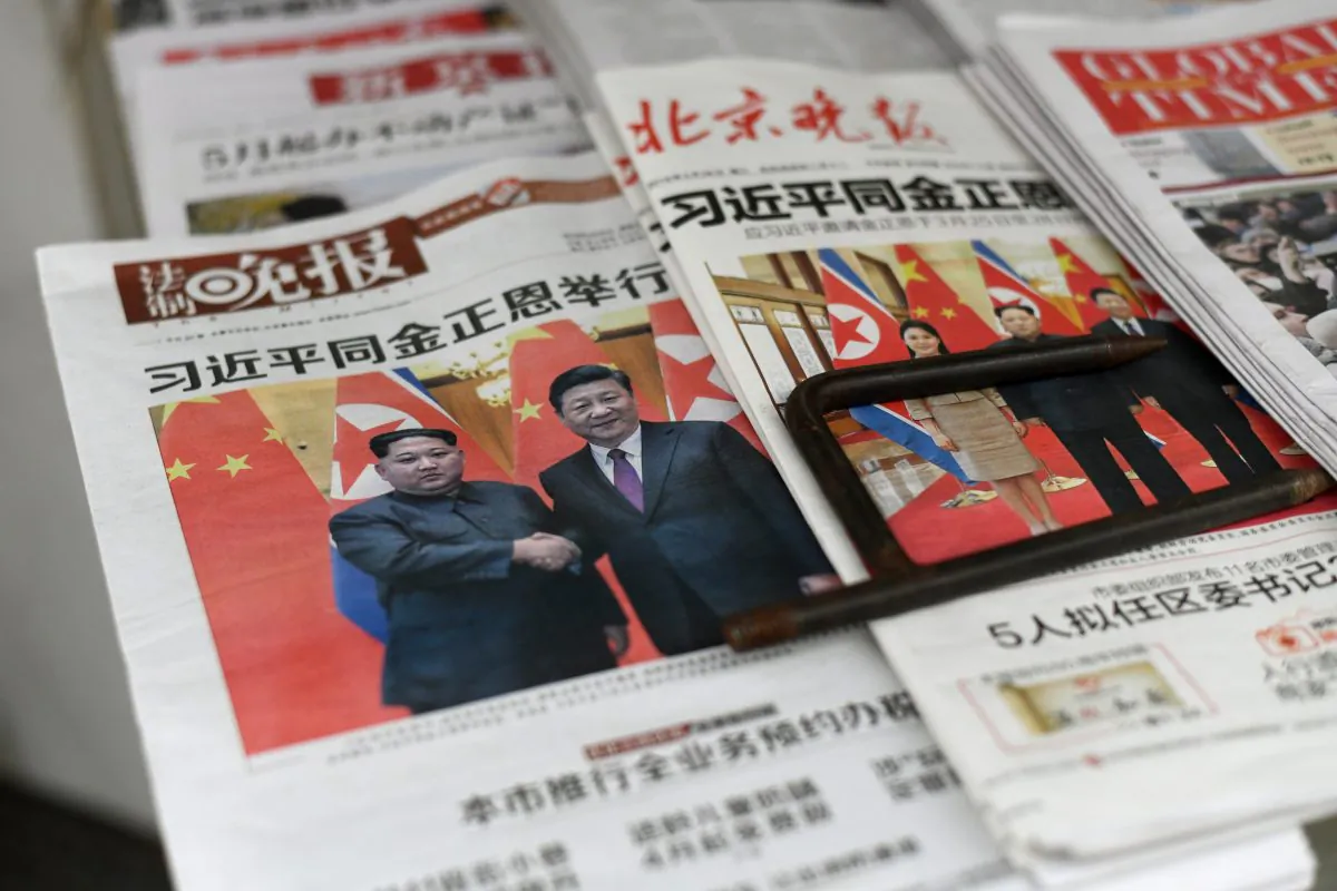 The front pages of Chinese newspapers showing images of Chinese leader Xi Jinping with North Korean leader Kim Jong Un, displayed at a newspaper stand in Beijing on March 28, 2018. (Fred Dufour/AFP/Getty Images)