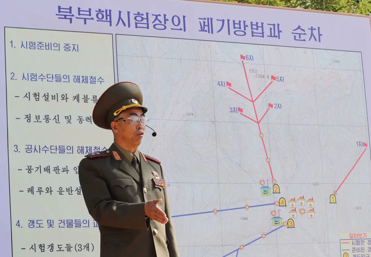 In this handout image provided by the News1-Dong-A Ilbo, a North Korean soldier explains the demolition process of the Punggye-ri nuclear test facility to the media at the Punggye-ri nuclear test site on May 24, 2018 in Punggye-ri, North Korea. (News1-Dong-A Ilbo via Getty Images)