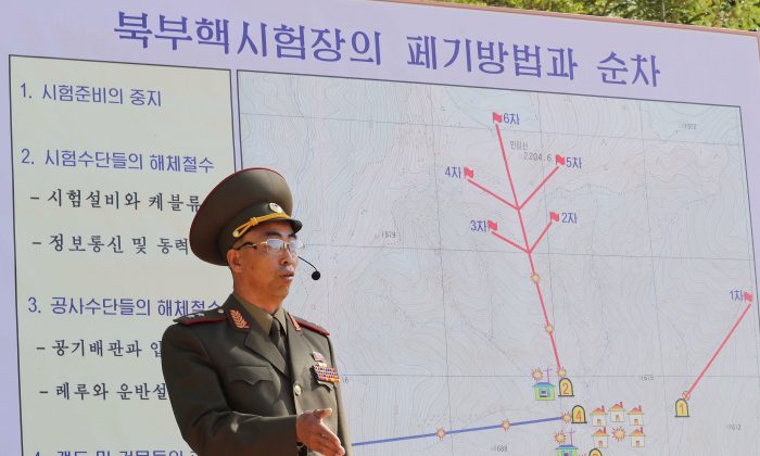 In this handout image provided by the News1-Dong-A Ilbo, a North Korean soldier explains the demolition process of the Punggye-ri nuclear test facility to the media at the Punggye-ri nuclear test site on May 24, 2018 in Punggye-ri, North Korea. (News1-Dong-A Ilbo via Getty Images)