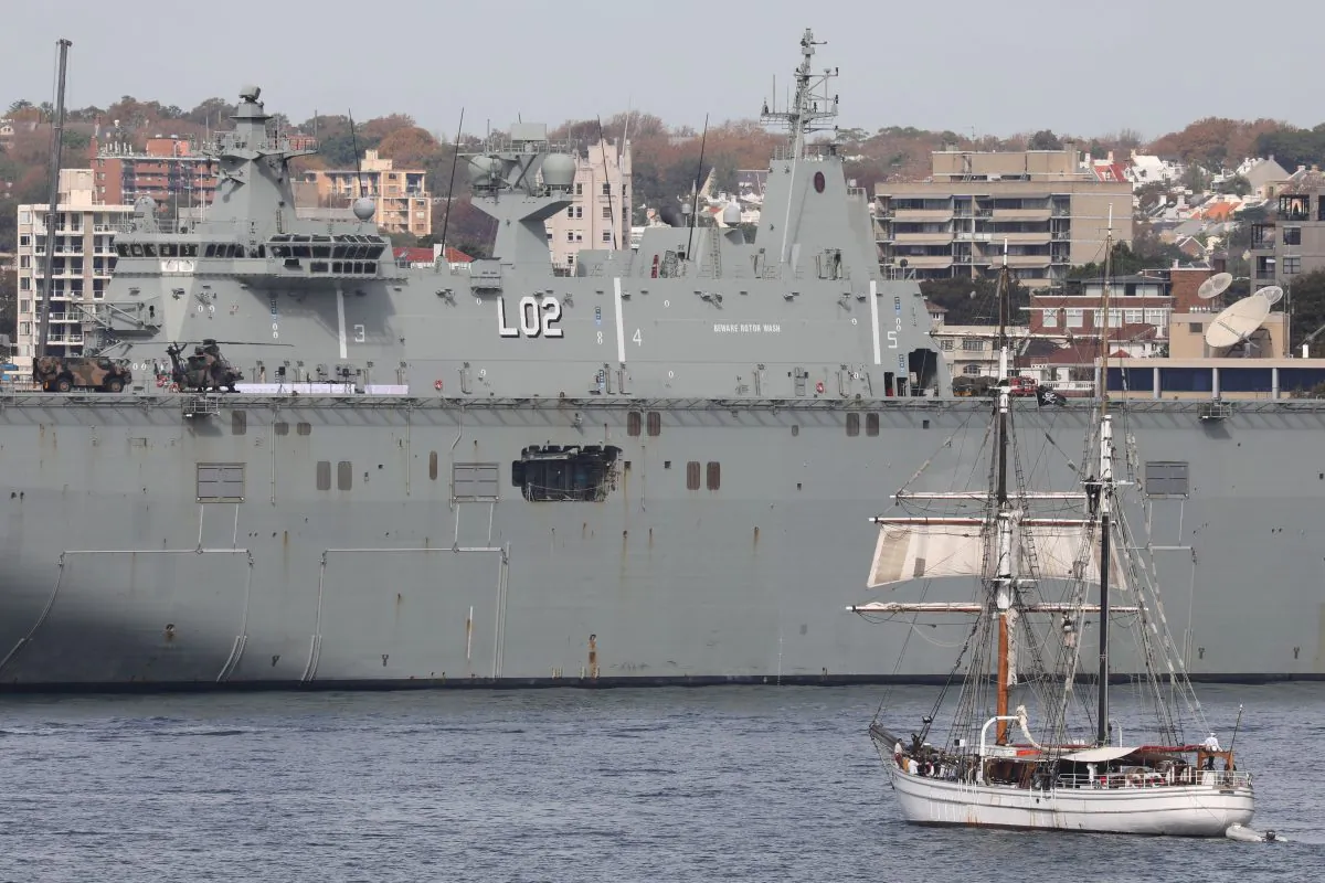 A boat sails near an Australian Navy vessel docked in Sydney on May 2, 2018. (Ludovic Marin/AFP/Getty Images)