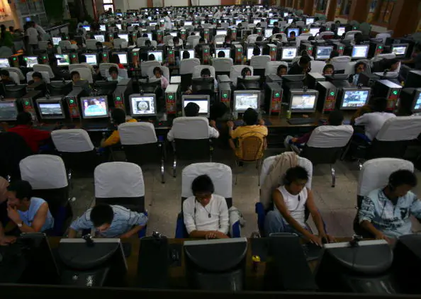 People surf the net at an internet cafe in Lhasa of Tibet Autonomous Region, China on Aug. 30, 2006. (China Photos/Getty Images)