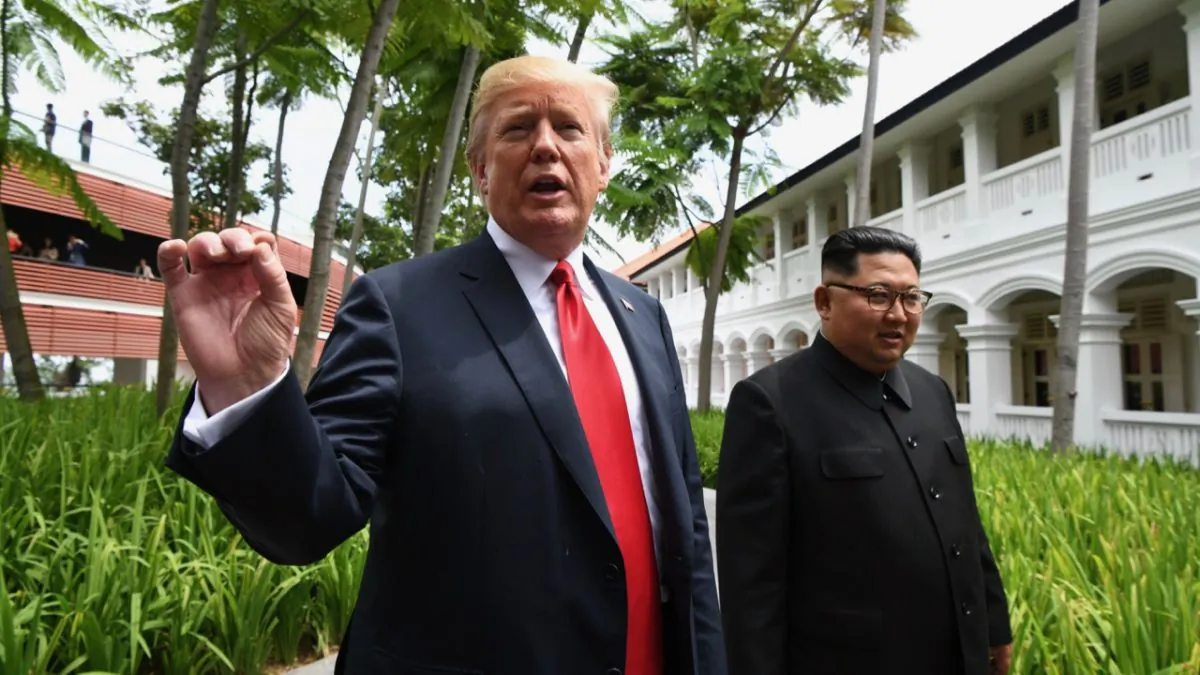 US President Donald Trump speaks to the media as he walks with North Korea's leader Kim Jong Un during a break in talks at their historic US-North Korea summit, at the Capella Hotel on Sentosa island in Singapore on June 12, 2018. (Anthony Wallace/AFP/Getty Images)