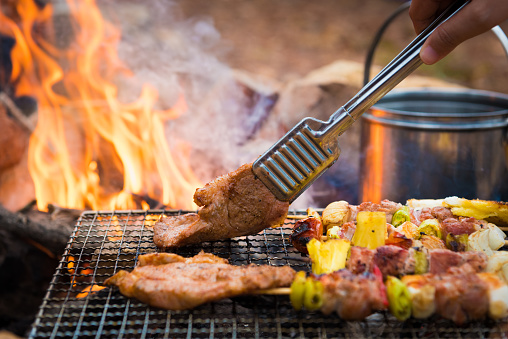 Close up grilling barbecue in the campground at summer camp travel, Skewers of pork and beef fillet on barbecue party in camping.(Getty Image)