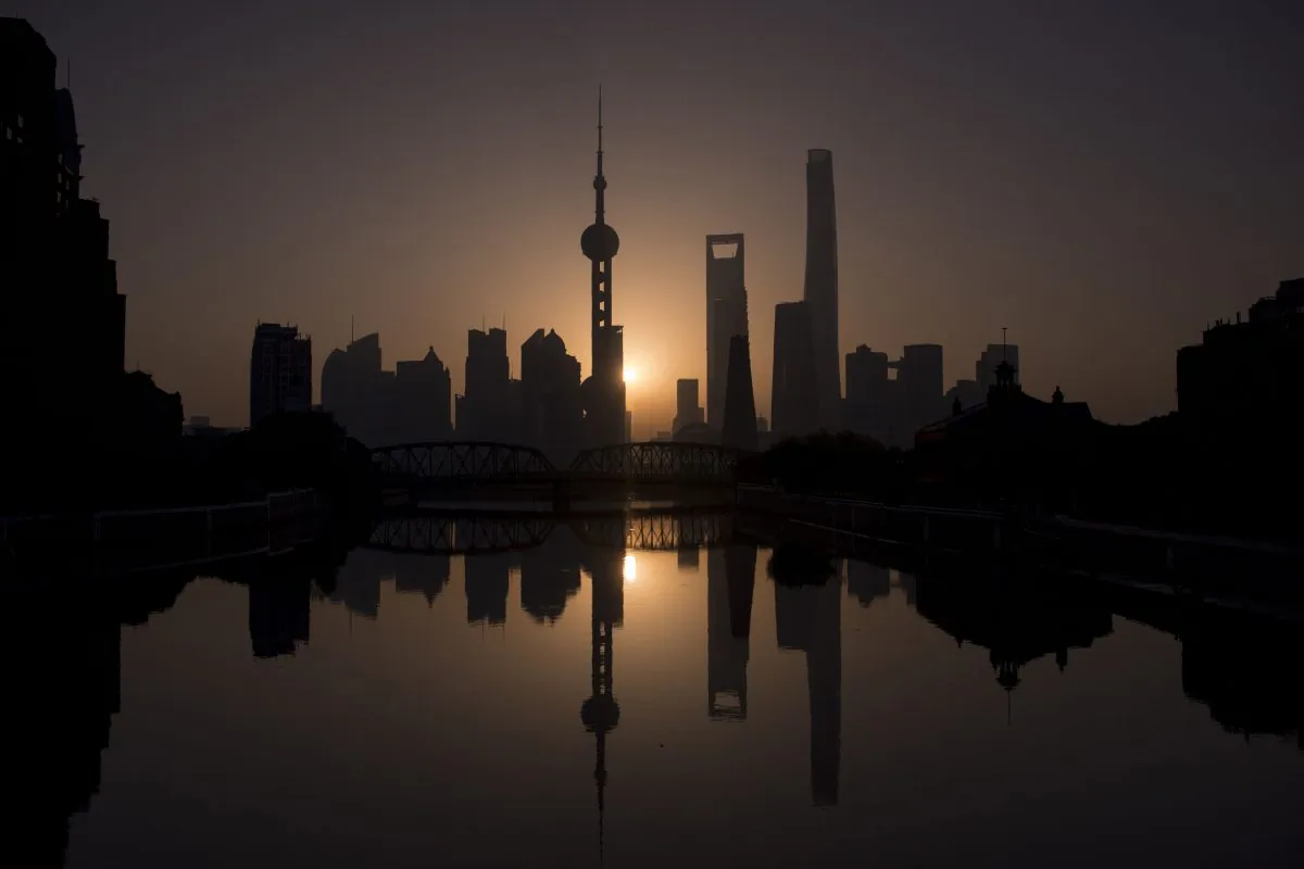 The sun rises behind the Shanghai skyline, overlooking the Pudong district on Nov. 11, 2016. (Johannes Eisele/AFP/Getty Images)