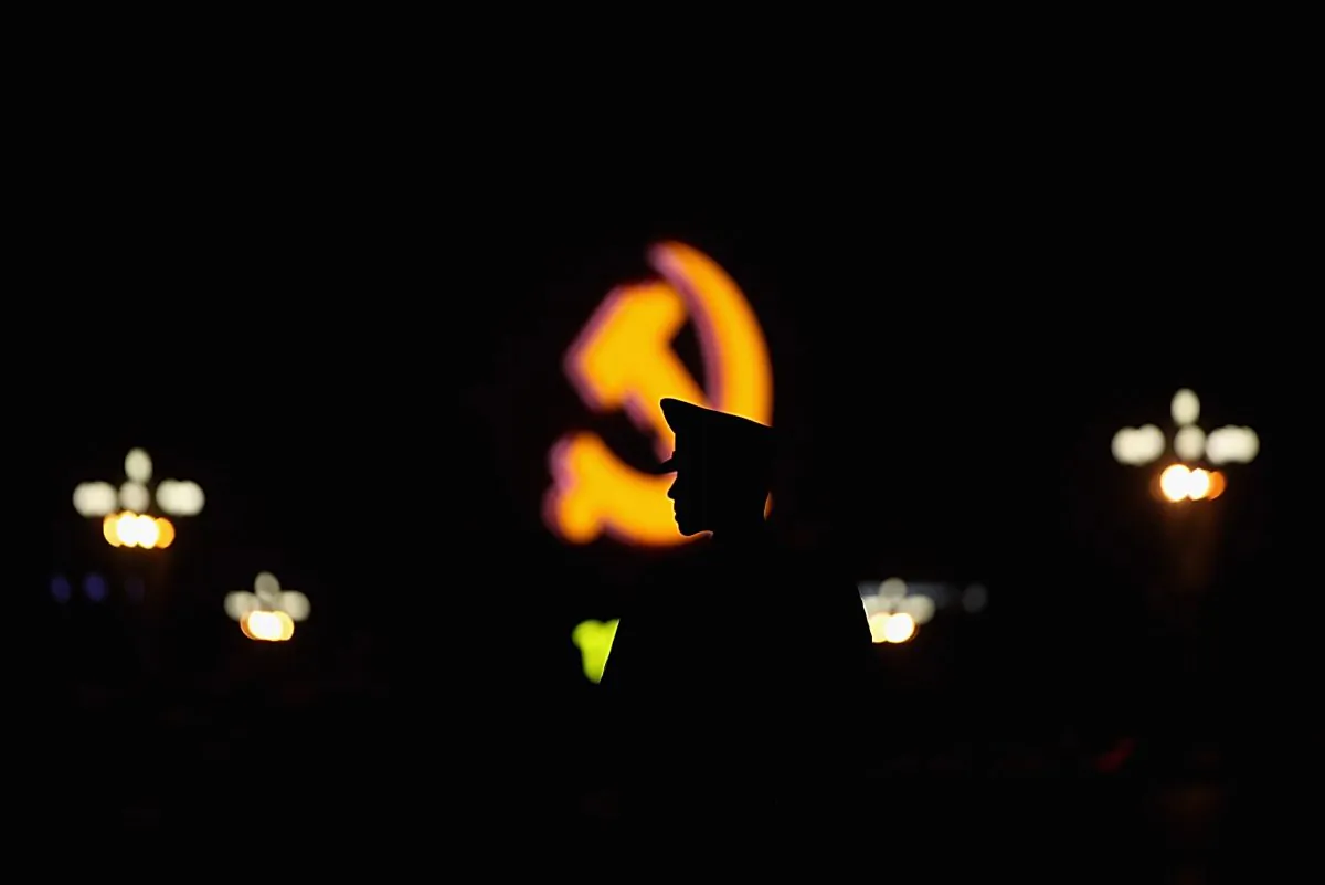 A paramilitary policeman stands guard in front of an emblem of the Chinese Communist Party at Tiananmen Square in Beijing on June 28, 2011.  (Feng Li/Getty Images)